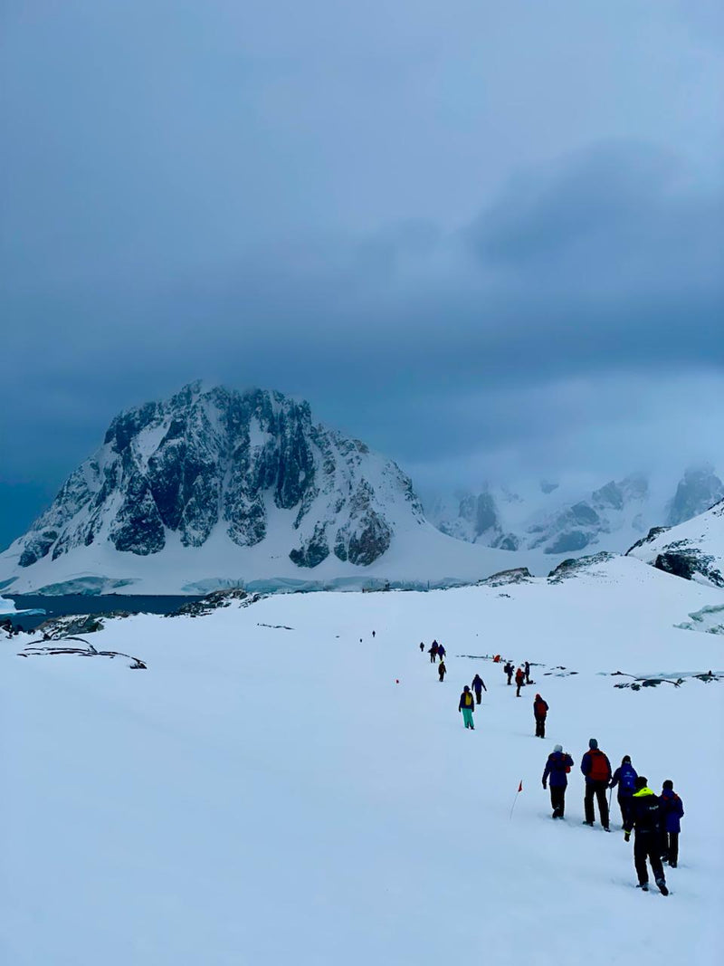 Explorers crossing a snowy polar landscape during a mountain expedition