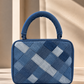 Close-up of Confluence Handbag showing intricate woven repurposed denim texture