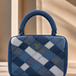Confluence Handbag showing intersecting strips of ice-blue and indigo denim