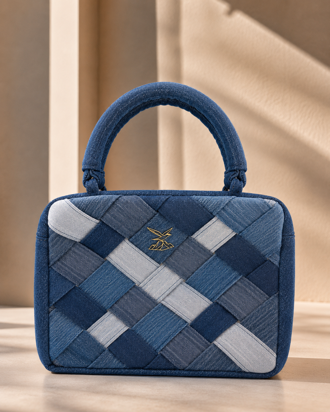 Confluence Handbag showing intersecting strips of ice-blue and indigo denim
