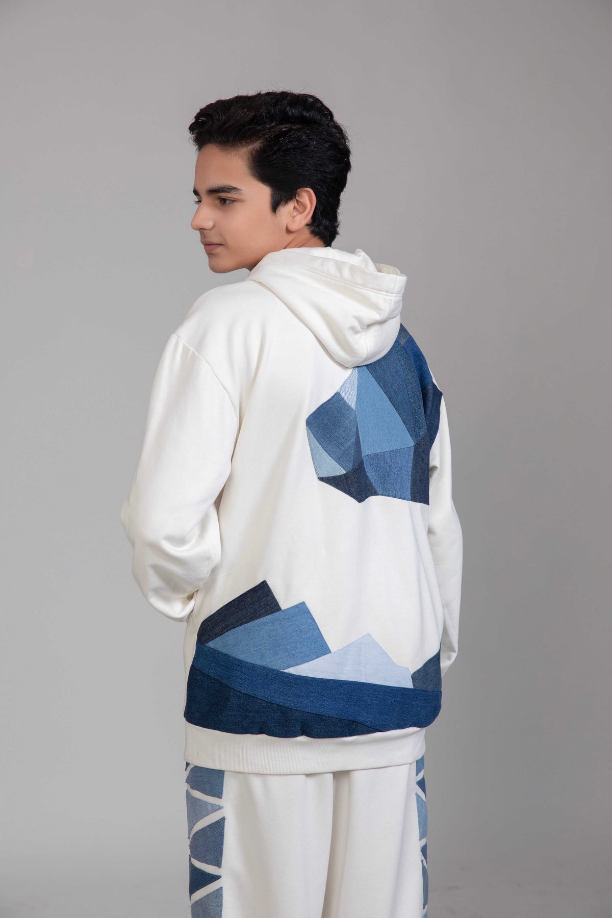 Close-up of Endurance Hoodie showing reconstructed denim polar landscape patchwork