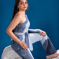 Fearless Ferð Denim Jumpsuit with one-shoulder silhouette and flared denim leg