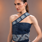 Side view of Flowform Denim Top showing its asymmetric single-sleeve silhouette