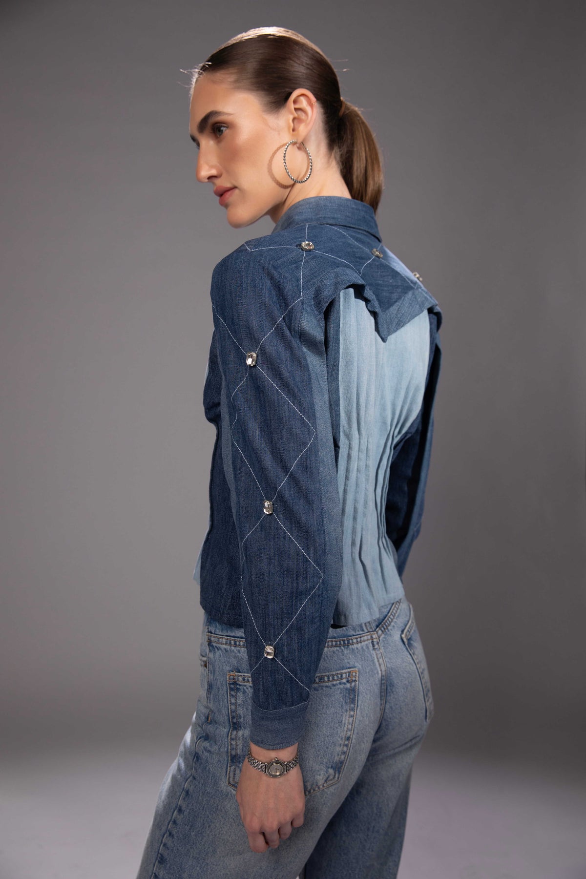 Side view of Glacier Cut Denim Top showing its sculptural silhouette