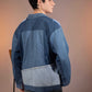 Back view of Glacier Ridge Denim Jacket with geometric mountain patchwork