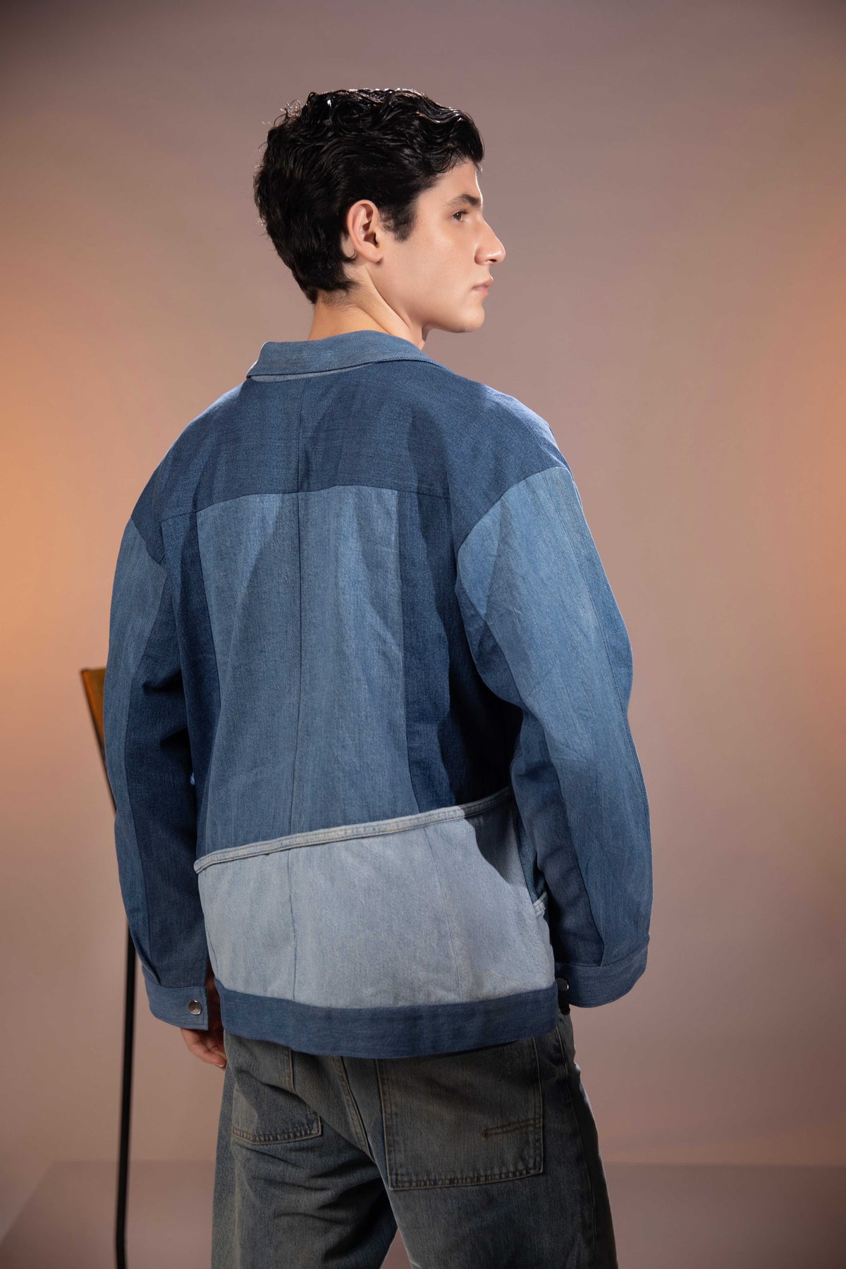 Back view of Glacier Ridge Denim Jacket with geometric mountain patchwork