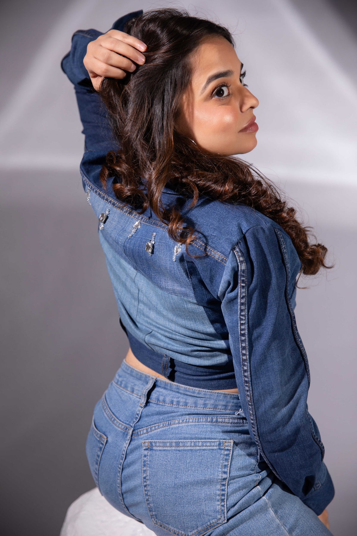 Side view of Ice Curve Denim Jacket showing its cropped silhouette