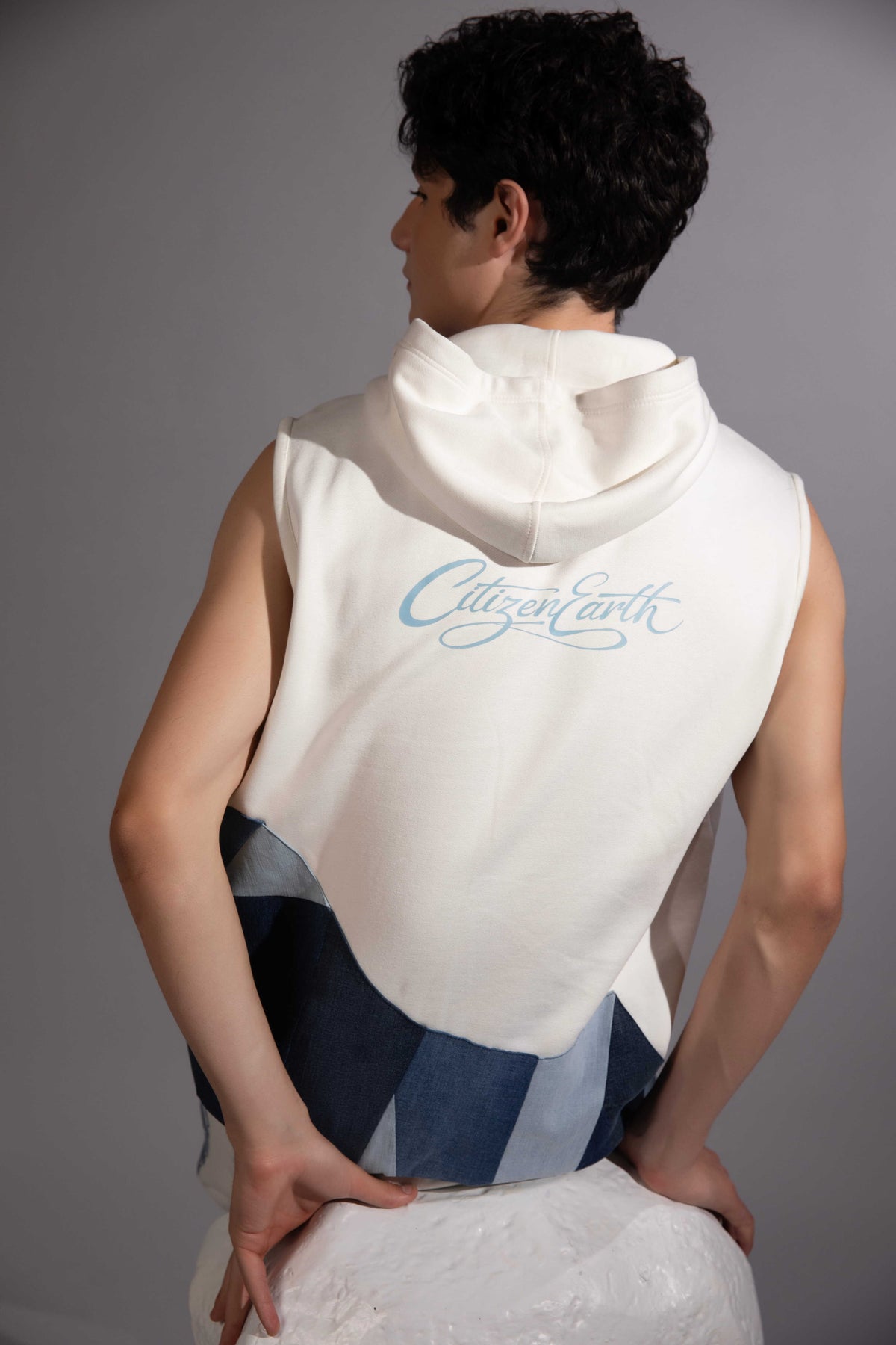 Back view of Layered Sleeveless Hoodie showing reconstructed denim patchwork