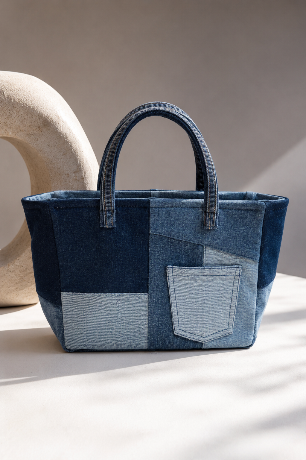 Close-up of Meridian Mini Tote Bag showing geometric repurposed denim panelling