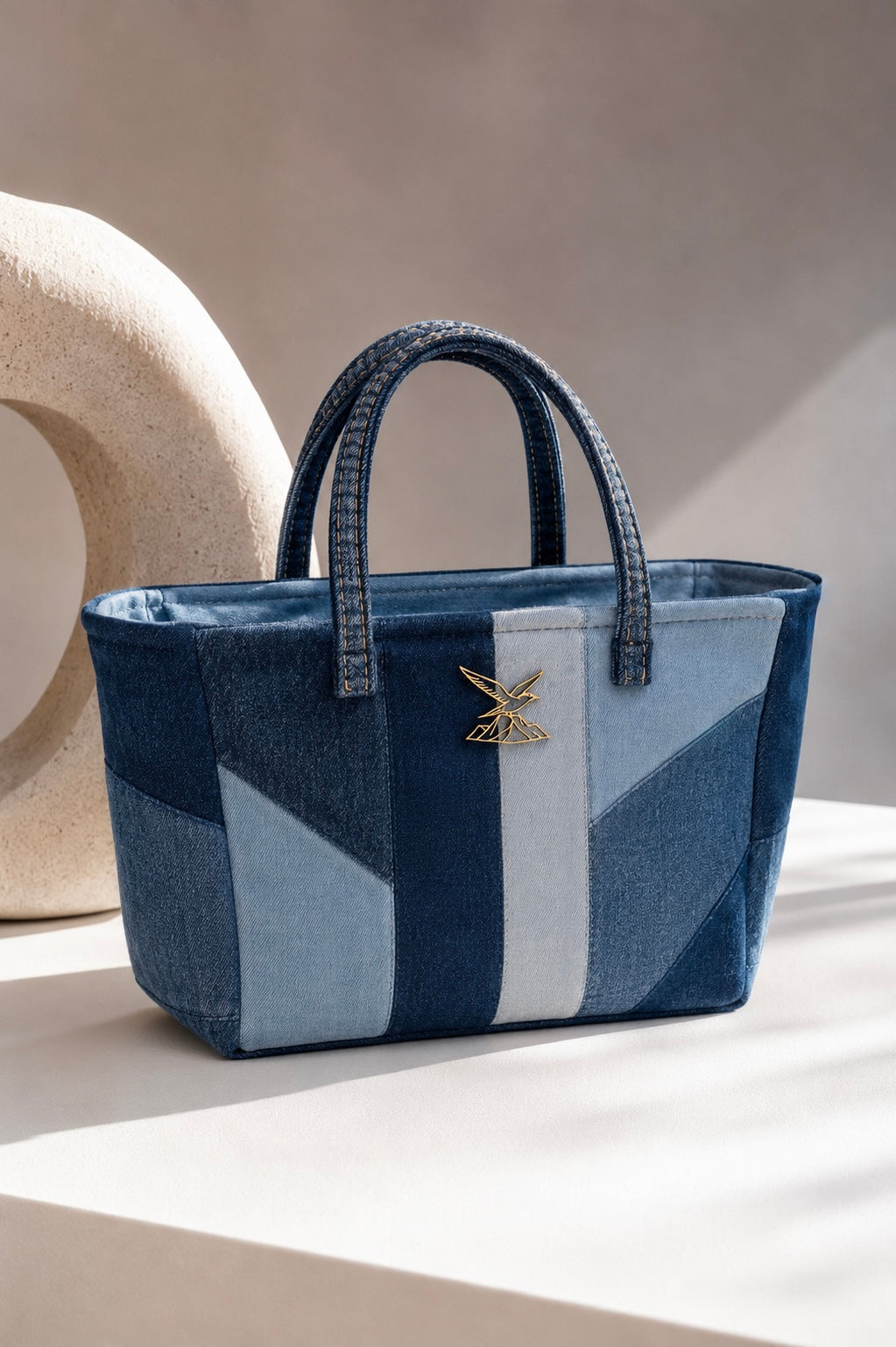 Meridian Mini Tote Bag showing contrasting ice-blue and deep-indigo denim panels