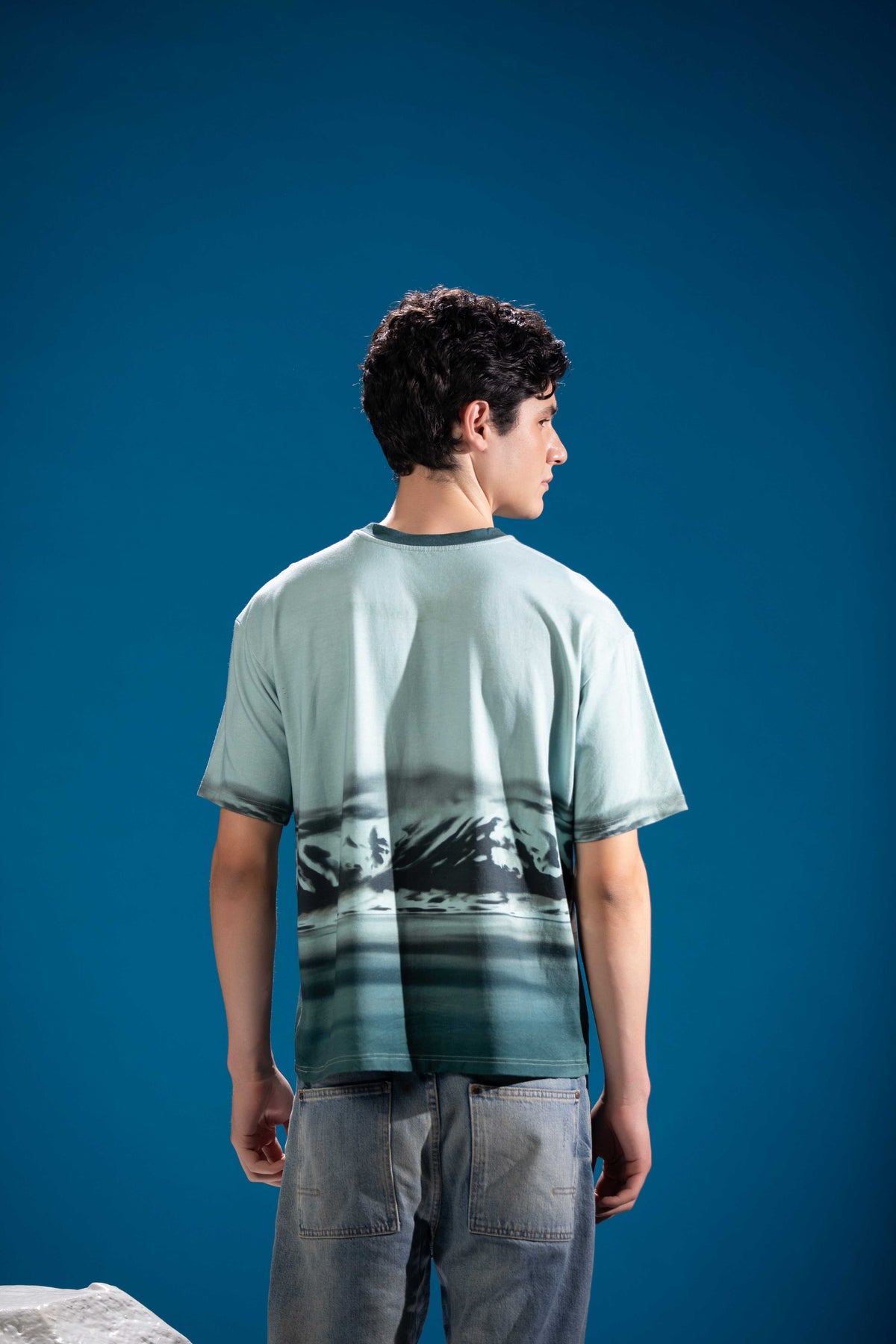 Close-up of Mountain Reflection Tee showing glacial mountain reflection artwork