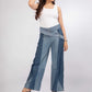 Close-up of Pleated Terrain Jeans showing structured pleat detailing