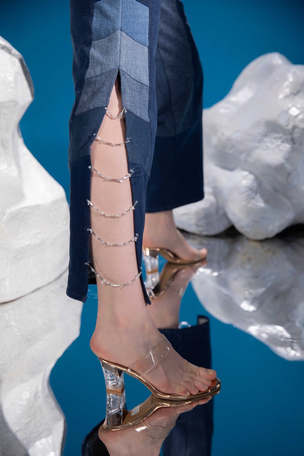 Close-up of Polar Terrain Denim Jumpsuit showing full sleeve, lapel collar, central zipper and bead detailing