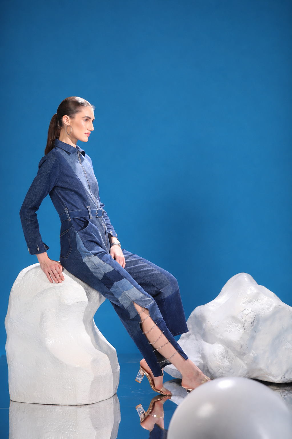 Side view of Polar Terrain Denim Jumpsuit showing its structured silhouette