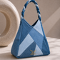 Close-up of Serac Handbag showing geometric repurposed denim panelling