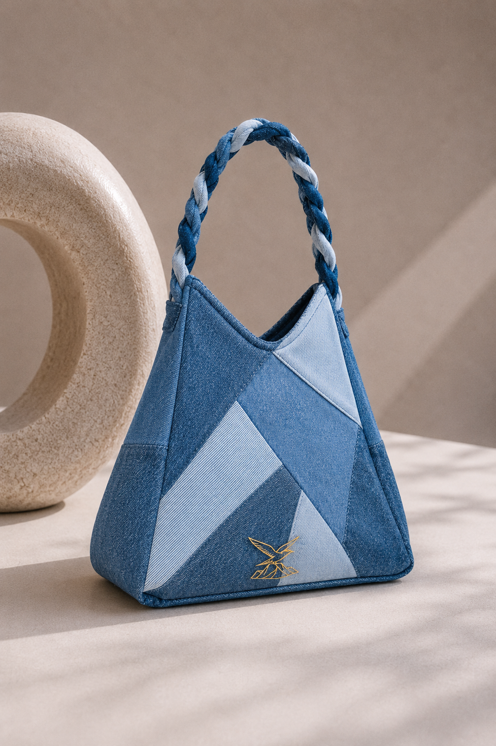 Close-up of Serac Handbag showing geometric repurposed denim panelling