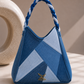 Serac Handbag showing faceted ice-blue and deep-indigo denim panels