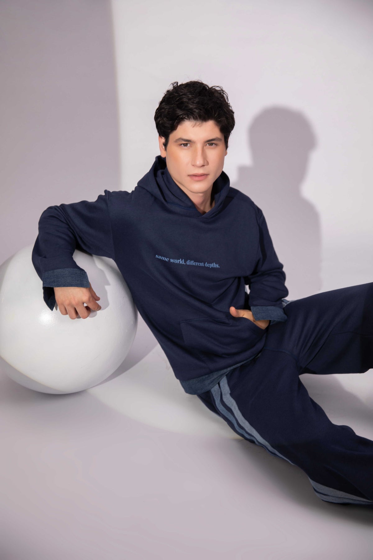 Shared World Hoodie showing contrasting repurposed denim hem detailing