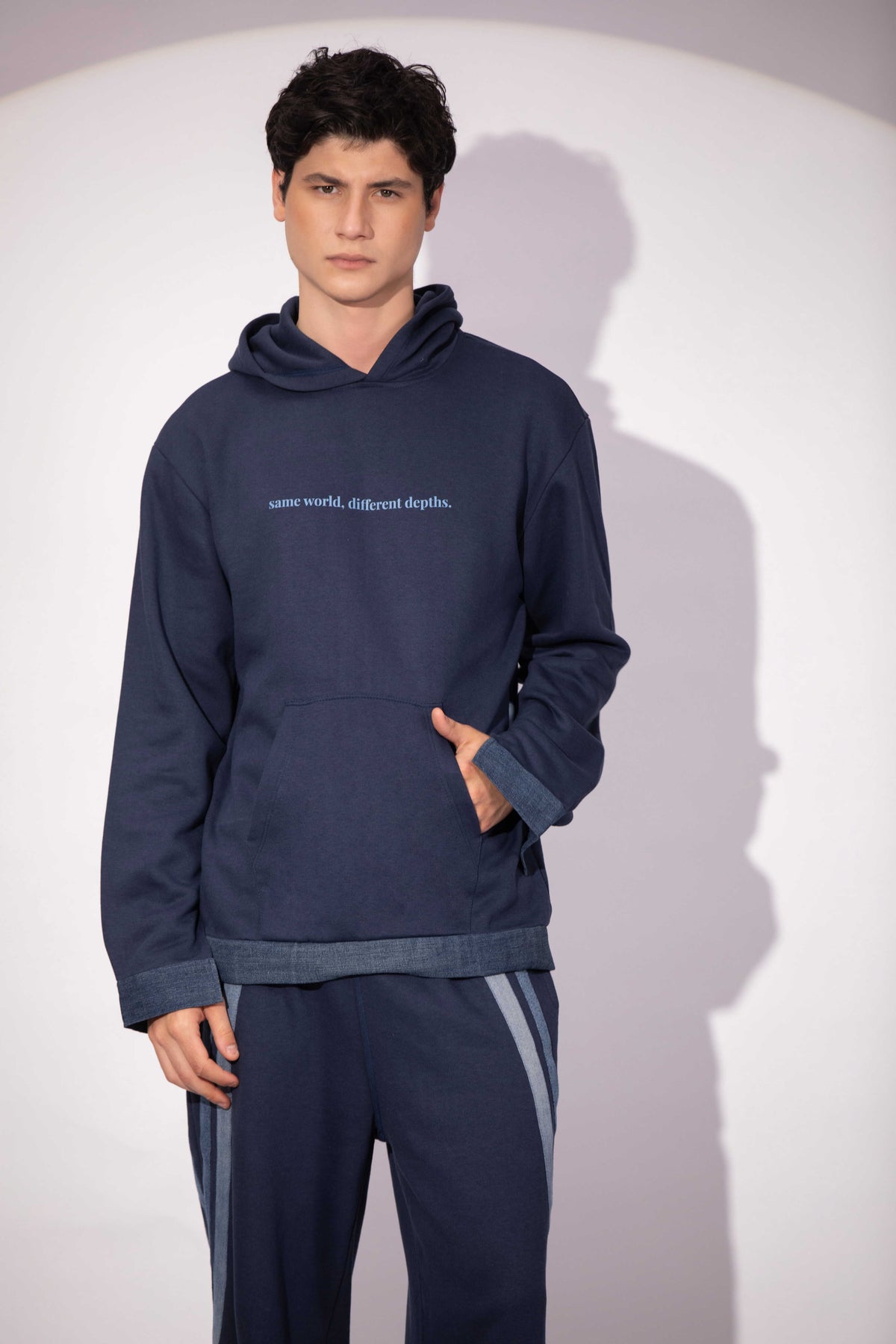 Shared World Hoodie in deep ocean blue with polar landscape artwork and denim detail