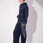 Side view of Shared World Hoodie showing its deep blue silhouette and denim detail