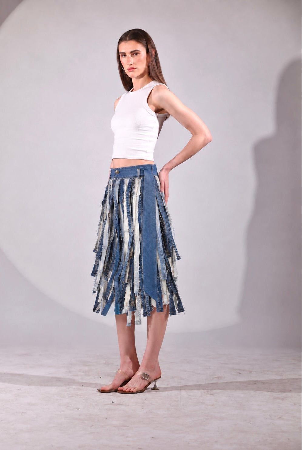Back view of The Meltwater Skirt featuring raw deconstructed denim strips