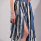 Close-up of The Meltwater Skirt showing deconstructed denim stripwork and frayed edges